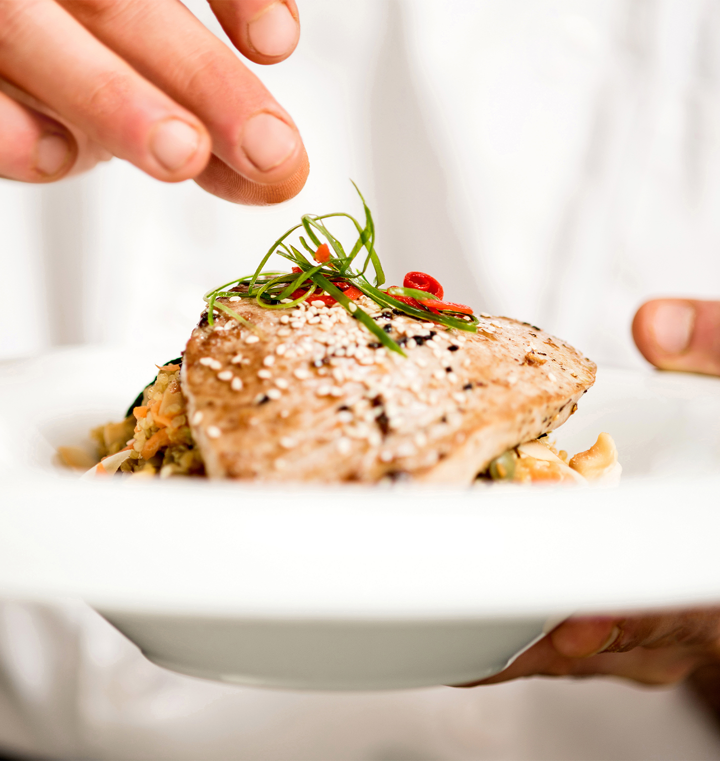 chef garnishing salmon