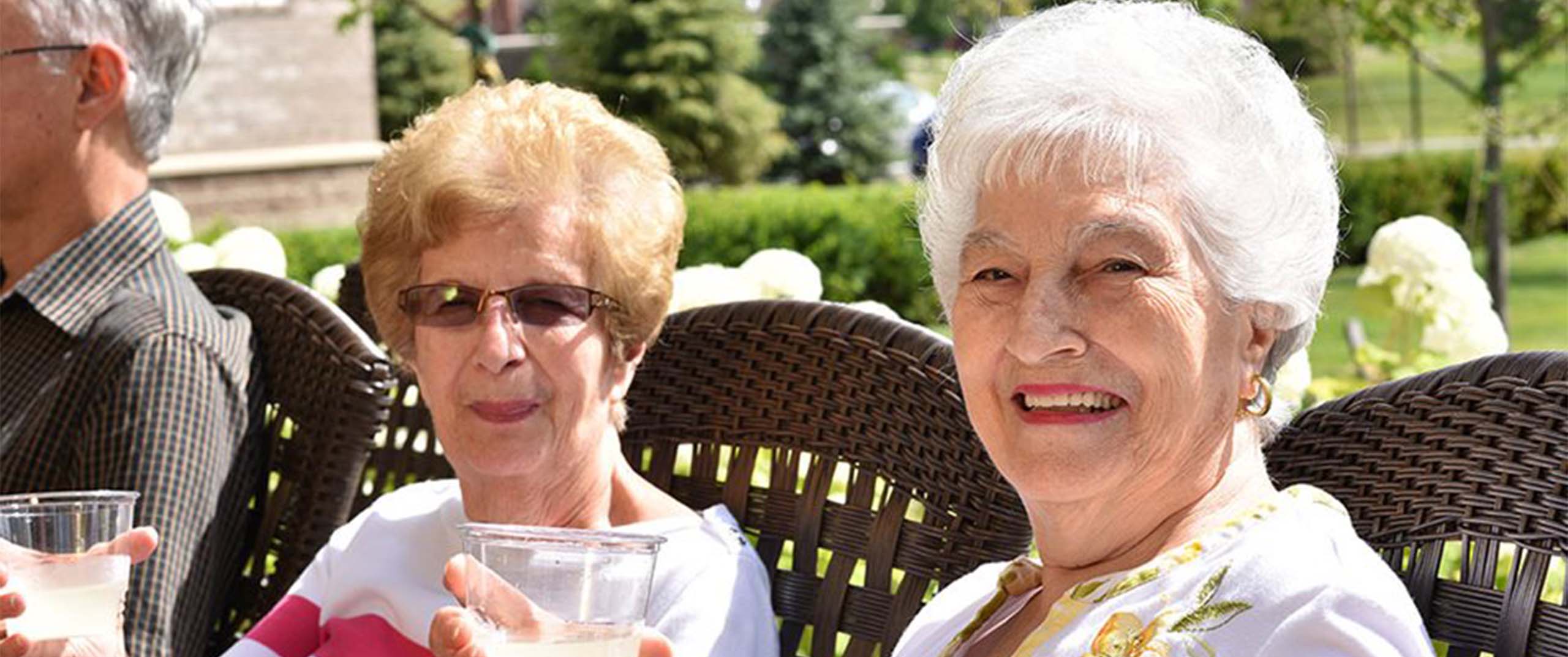 Two Woman Sitting and Smiling together