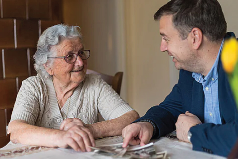 Senior woman talking to younger man